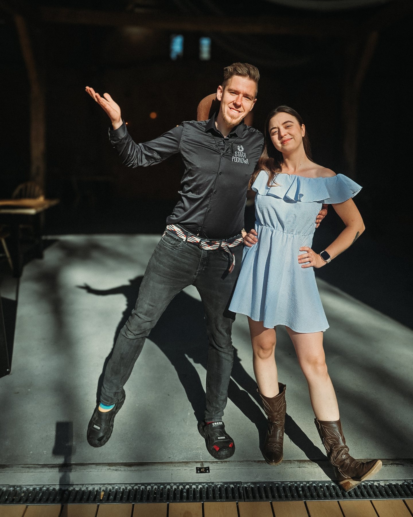 Iza and Tomek, the hosts of Stara Podkowa, laughing in the barn